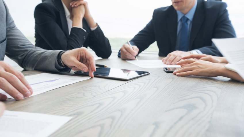 Business people work with documents and computers at office table close up.