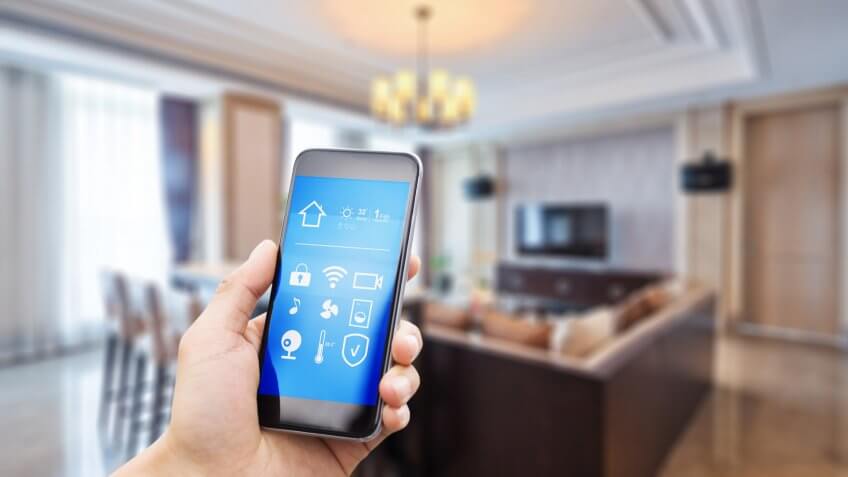 smart phone with apps in luxury living room.