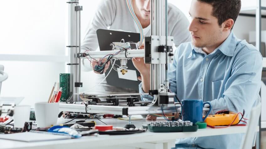 two men working on machinery technology