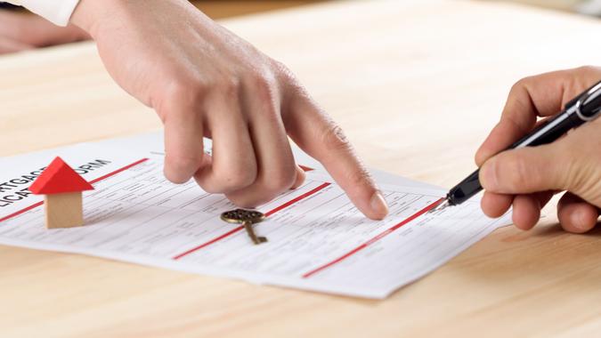 New homeowner signing contract of house sale or mortgage papers.