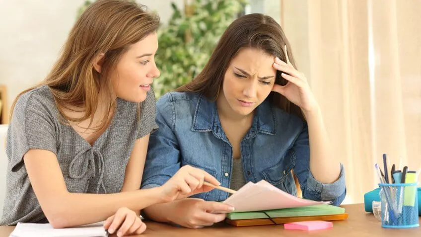 woman explaining something to another confused woman