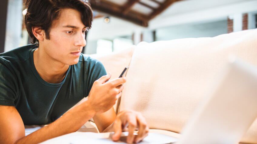 Cheerful text messaging and surfing on the couch.