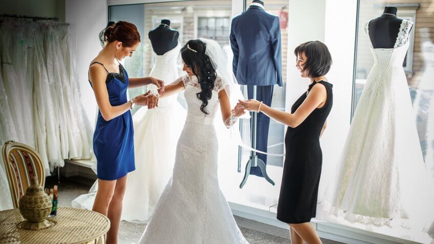 woman trying on a wedding dress