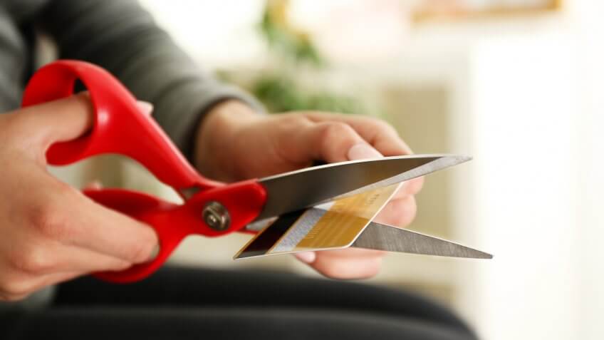 woman cutting her credit card