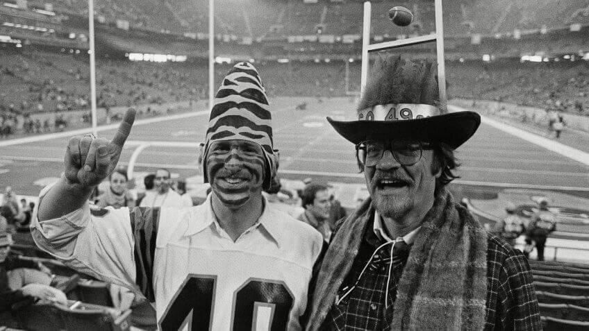 Mark Elmlinger, left, from Cincinnati, wears tiger stripes on his face and a Bengals conehead hat, as he is joined in Pontiac's Silverdome on by San Francisco 49ers fan Ed Schmitt, of Palo Alto, Calif.