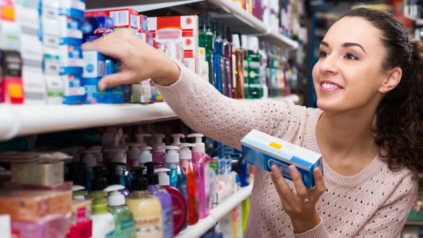 woman in a store buying toiletries