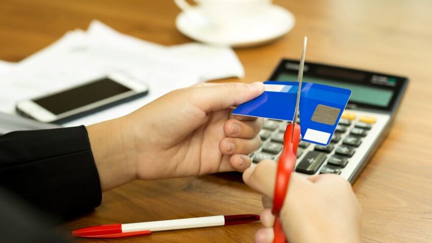 woman cutting up her credit card