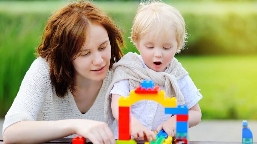 woman and child playing with legos