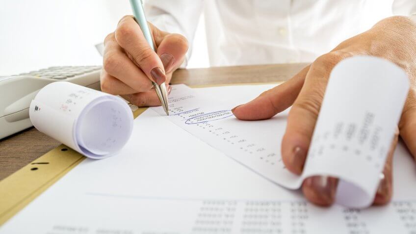 woman writing on a receipt