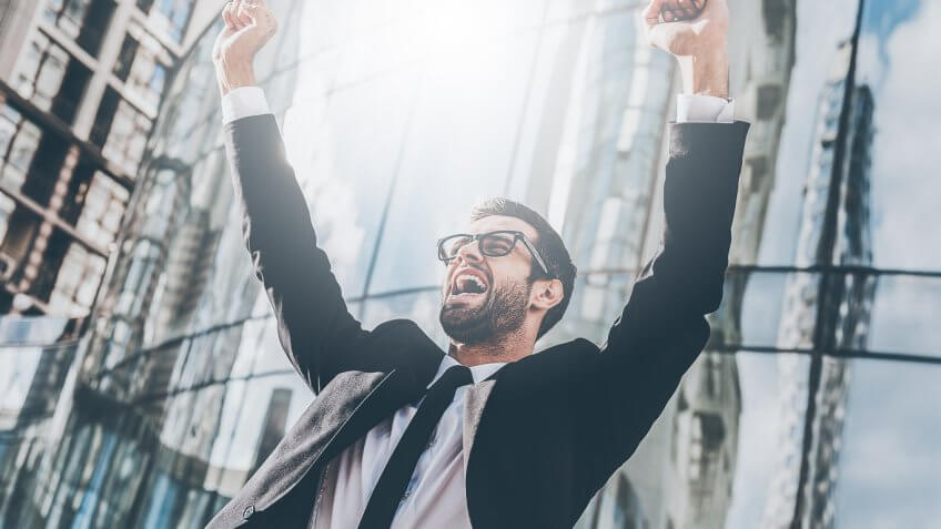 man with arms up victory pose