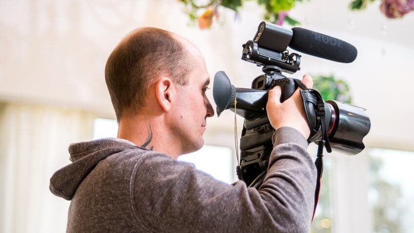 videographer man operating a camera