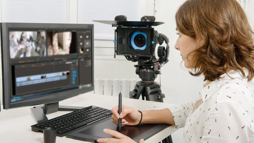 video editor working on her tablet and computer