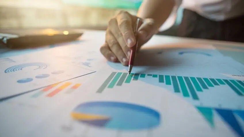 person annotating charts and graphs