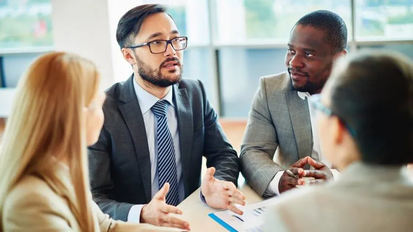 Man speaking to a group of coworkers
