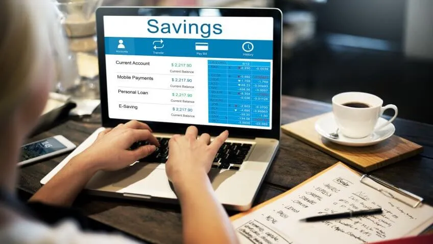 woman looking at her bank savings account on her laptop