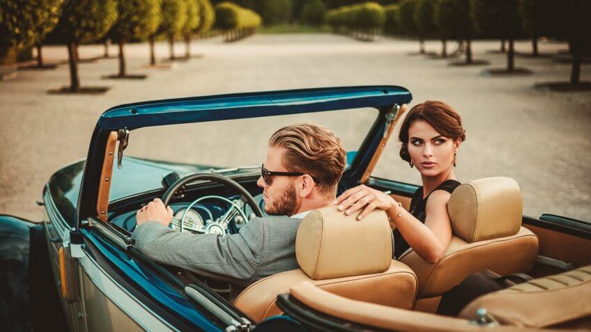 stylish young couple in a convertible