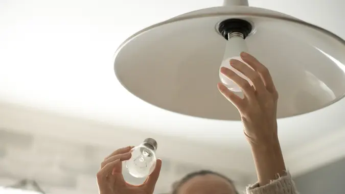 person replacing lightbulbs