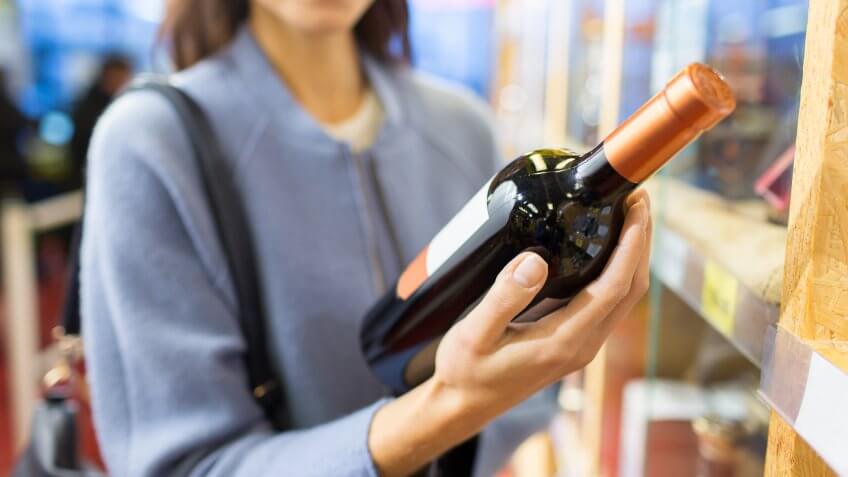 woman buying a bottle of wine