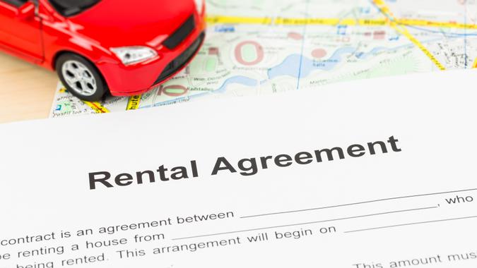 rental agreement over a map next to a toy car