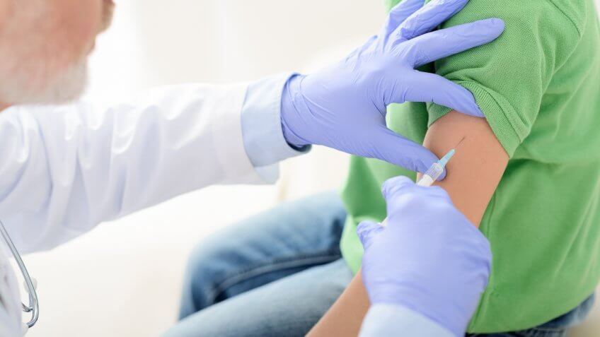 person getting a flu shot from a doctor