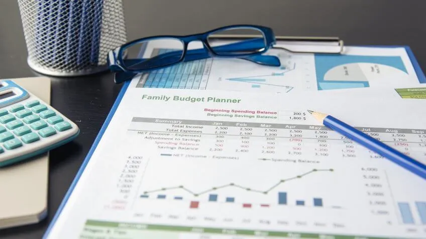 family budget planner close up under pencil and glasses
