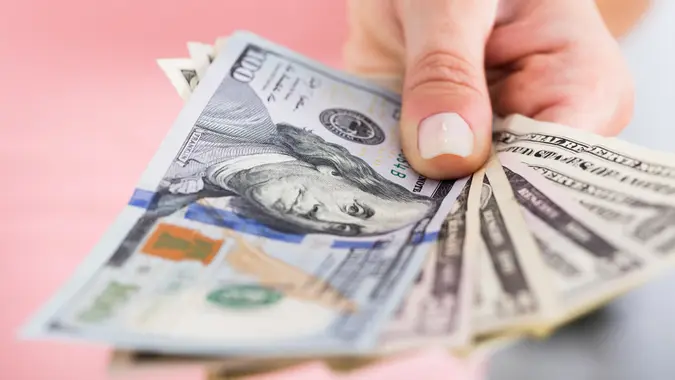 woman fanning money cash