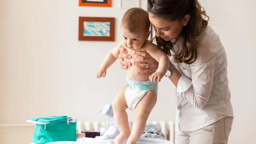 woman holding baby wearing a diaper
