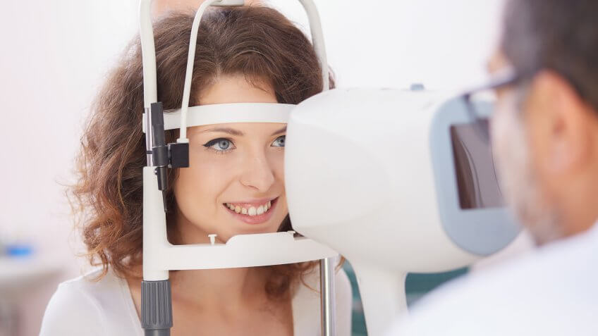 woman getting an eye exam with an optometrist