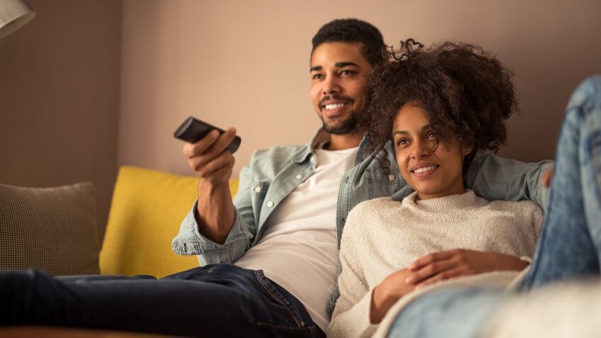 young couple watching tv together television