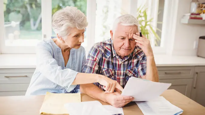 elderly couple reviewing paperwork