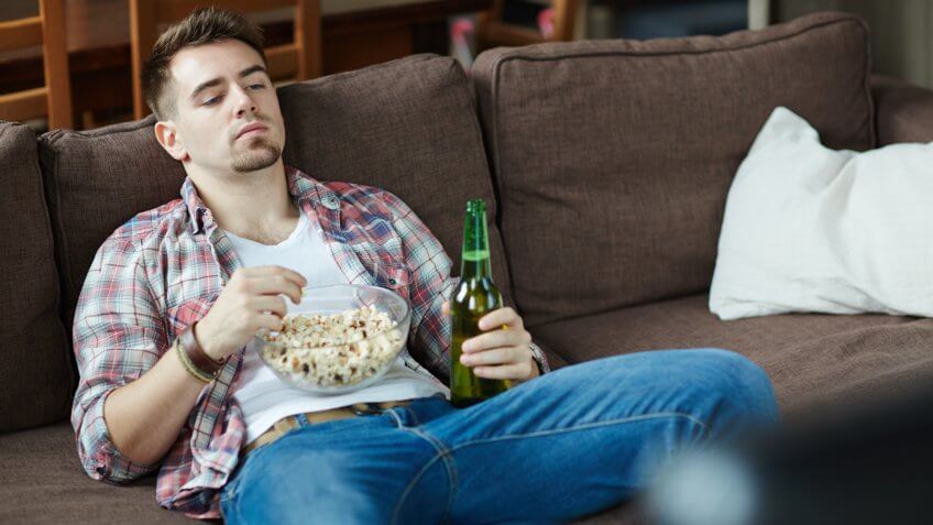 bum, couch potato, deadbeat