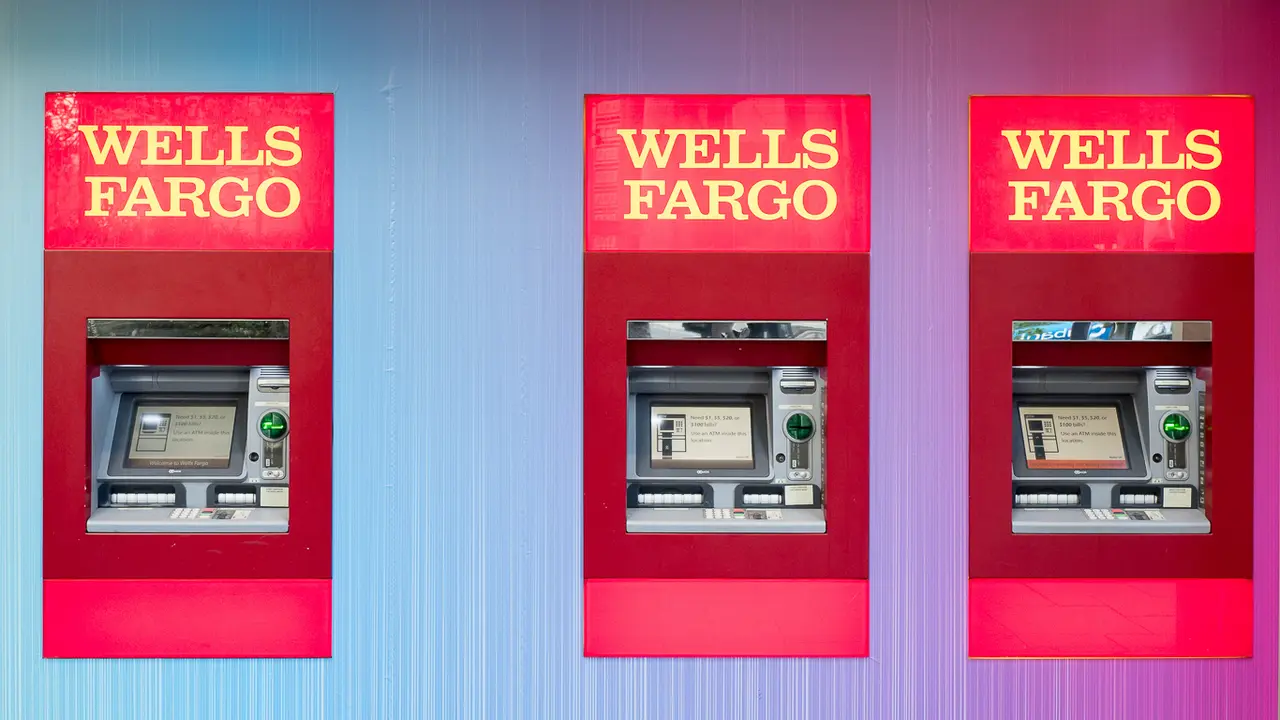 Three Wells Fargo ATMs in a row on a colorful wall.