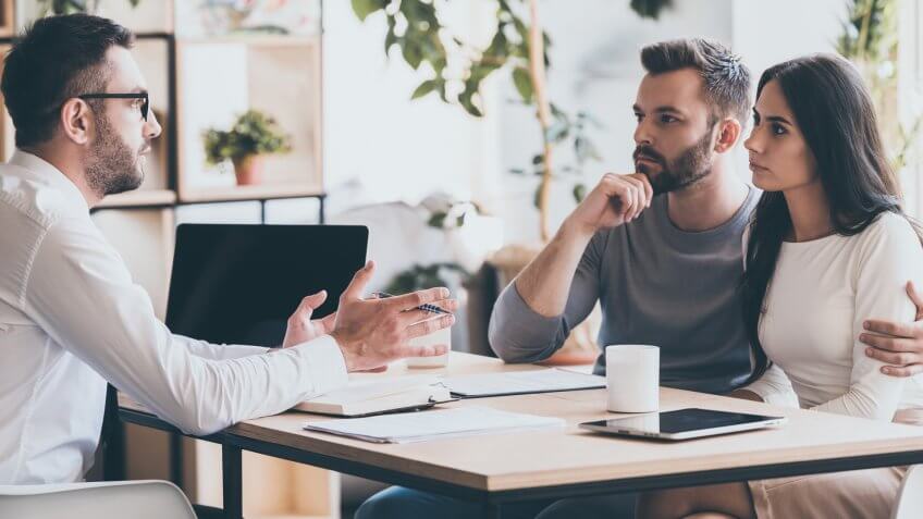 couple listening to financial consultant