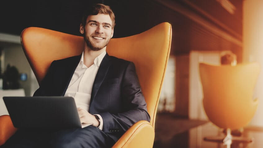 man on his laptop looking out of the window