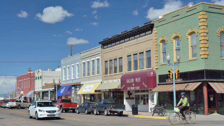 Laramie, Wyoming, USA - March 30, 2013: Downtown Laramie, Wyoming with a cyclist and other people.
