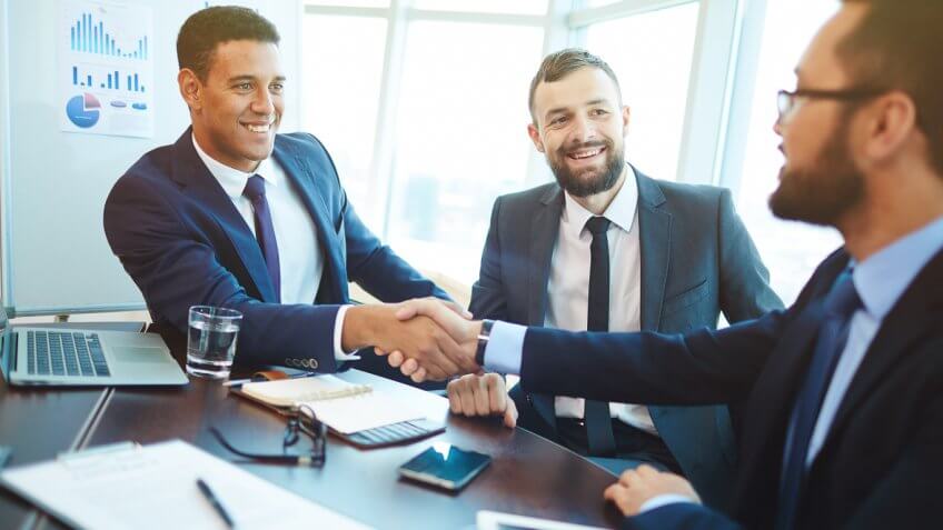 businessmen shaking hands at a meeting