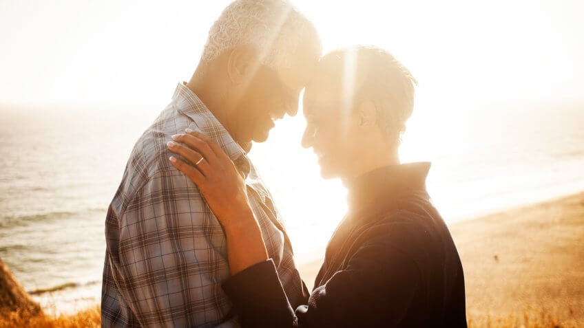 Cute senior couple enjoying a private moment overlooking the beach.