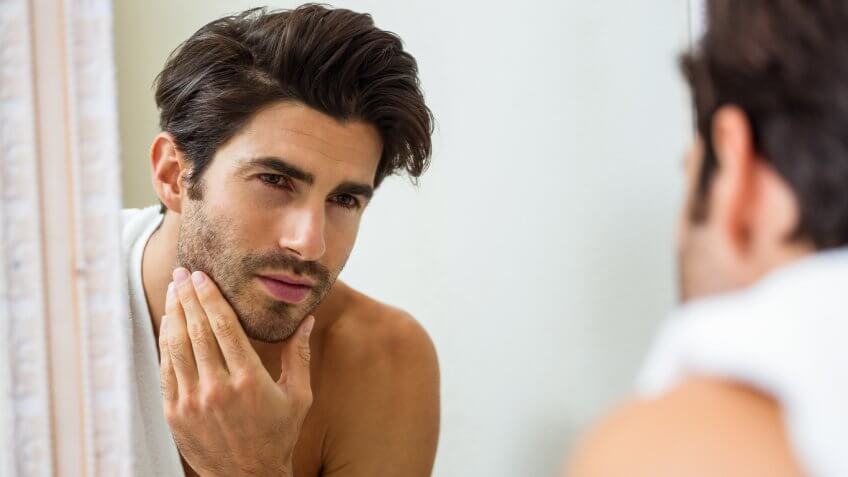 man looking at himself in the mirror