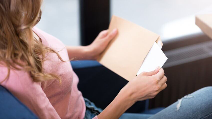 woman opening a letter