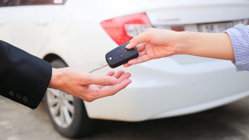 person passing car keys to someone else
