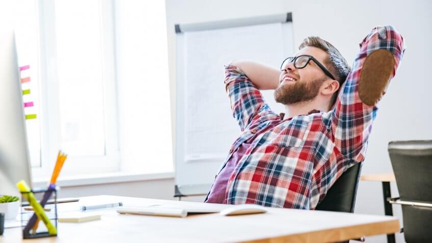 man sitting back looking proud