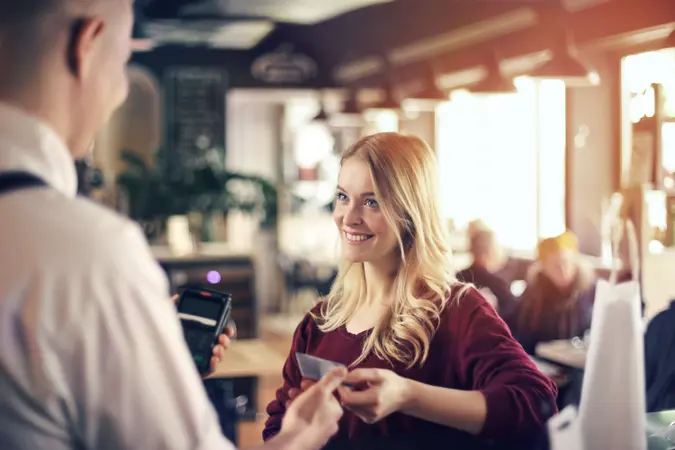 Woman is paying with credit card.