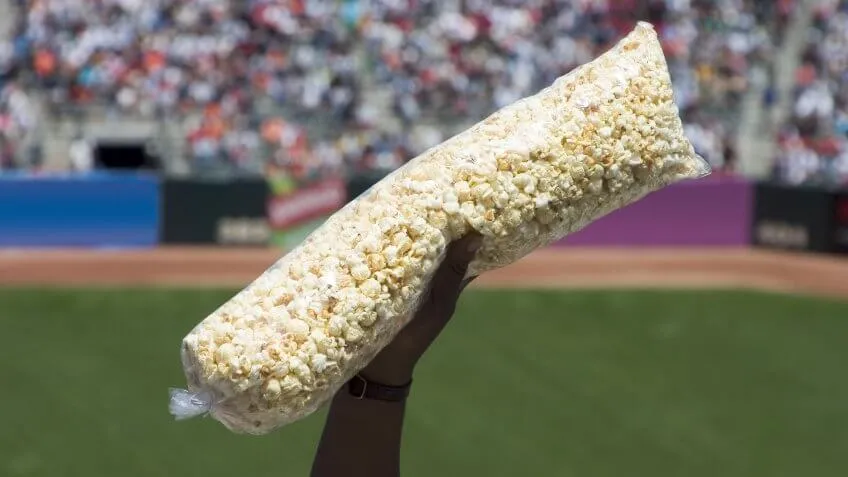 person holding a large bag of popcorn