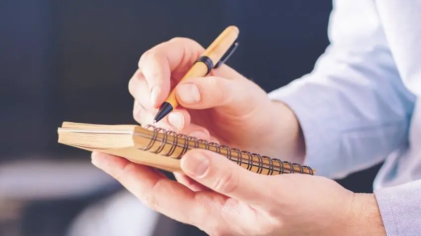 person writing in a notebook