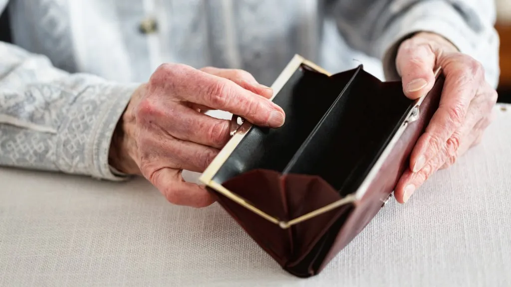 Hands holding empty purse.