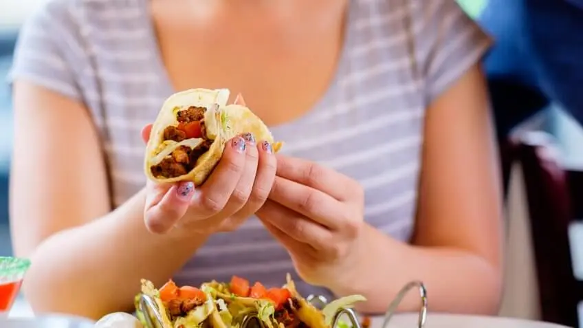 woman holding a taco
