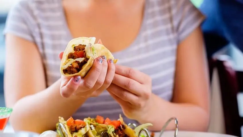 woman holding a taco
