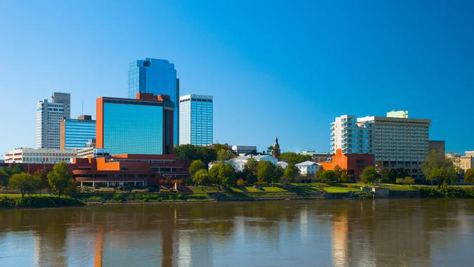 Little Rock's downtown skyline with the Arkansas River in the foreground.