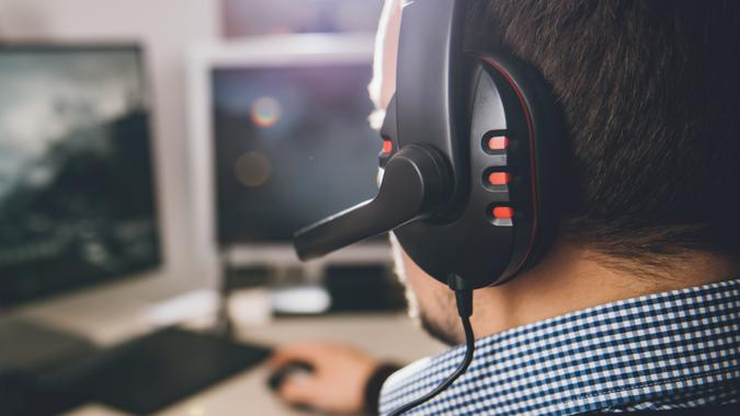 guy playing video games online with headphones