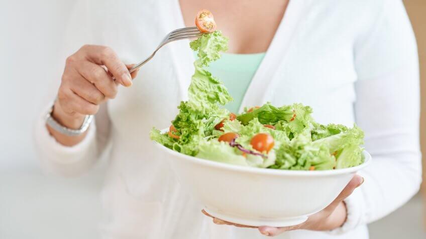 woman eating a bowl of salad